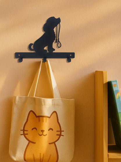 Dog silhouette hook rack mounted on a wall with a tote bag hanging from it